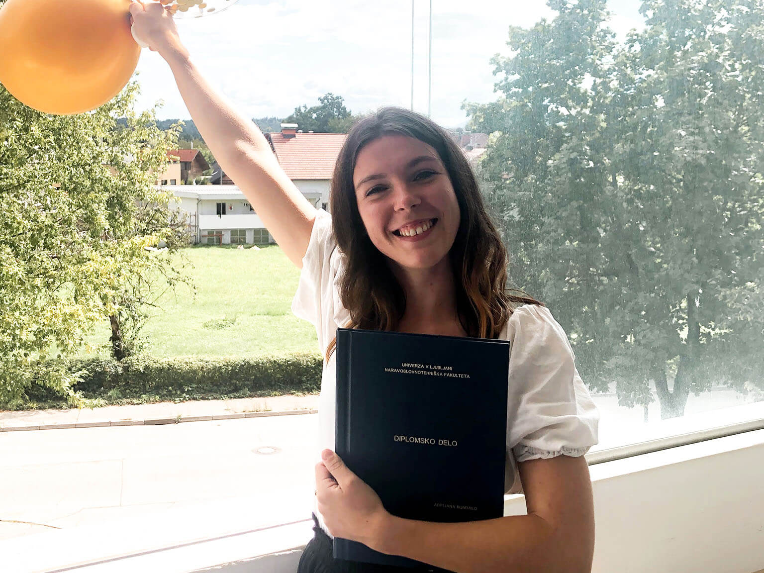 Woman holding thesis